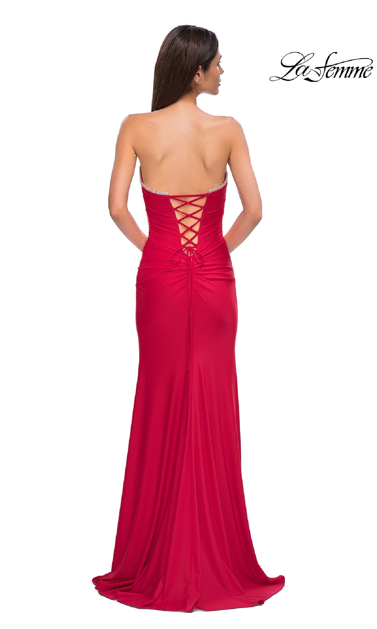 A woman in the La Femme 32931 Lace-Up Strapless Long Prom Dress with a rhinestone sweetheart neckline stands with her back to the camera, showcasing the lace-up back detail.